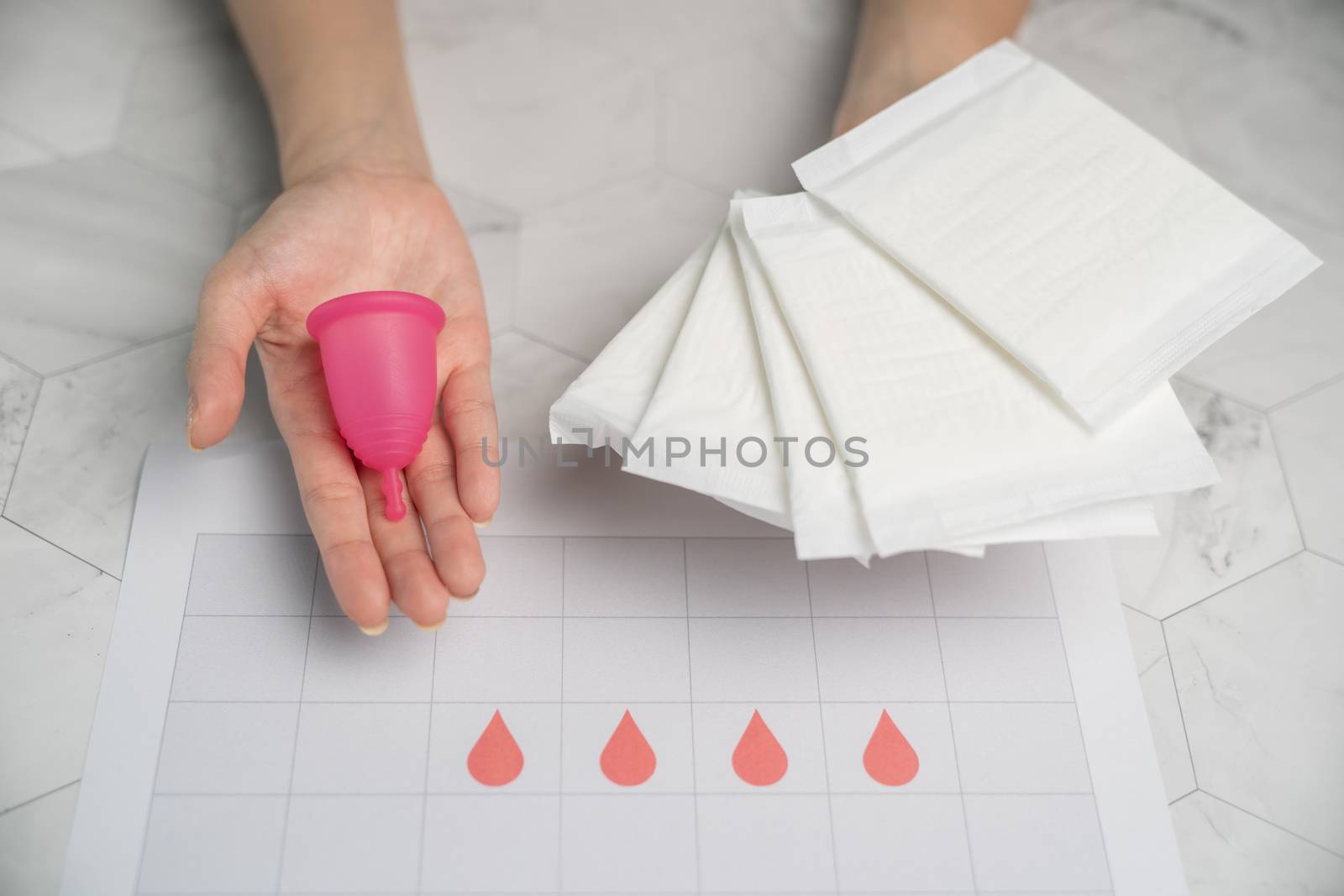 The choice between menstrual cup and sanitary napkin on woman ha by sirawit99