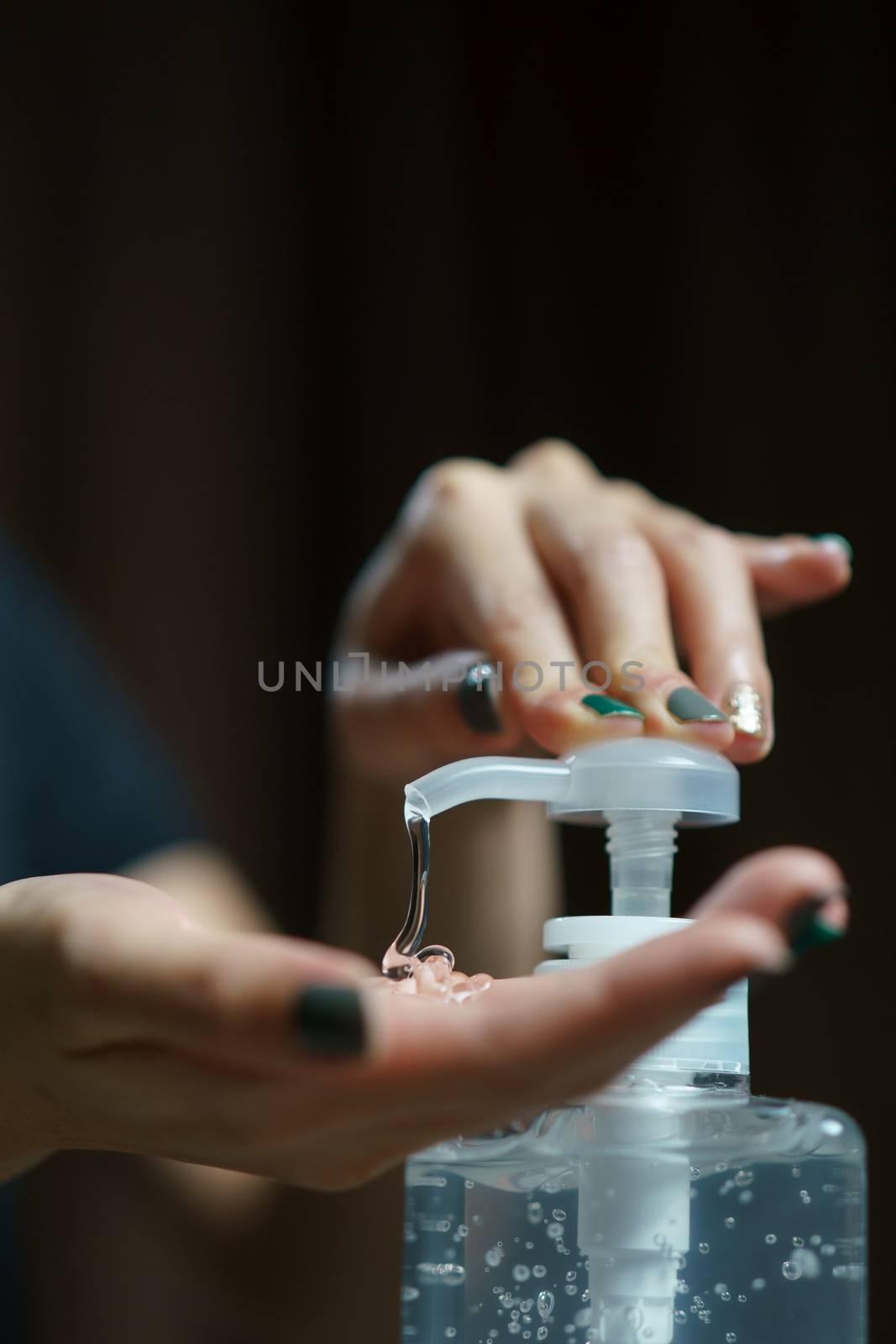 hands using wash hand sanitizer gel pump dispenser. Clear saniti by sirawit99