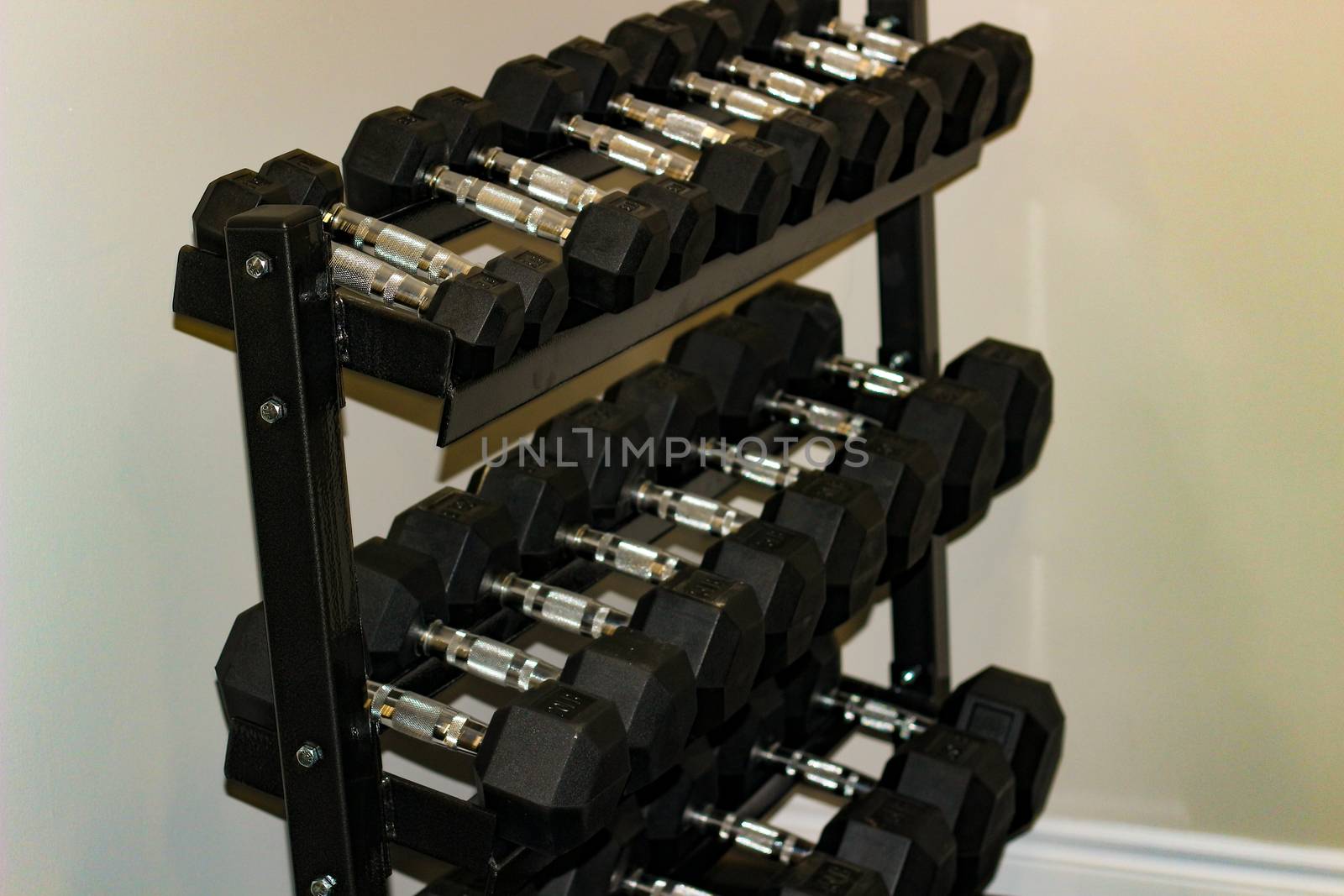 Every size of dumbbell on its rack in a fitness room. Is provided for customers, villagers or livers practice weight training exercise for their muscle strength by mynewturtle1