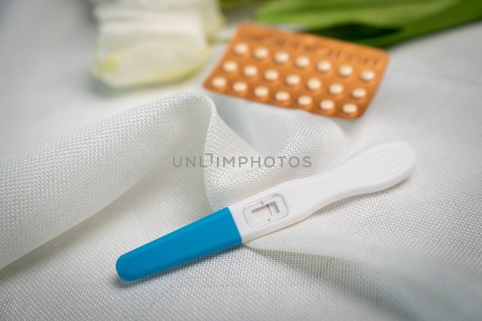 Pregnancy test and Birth control pill on white background. Conce by sirawit99