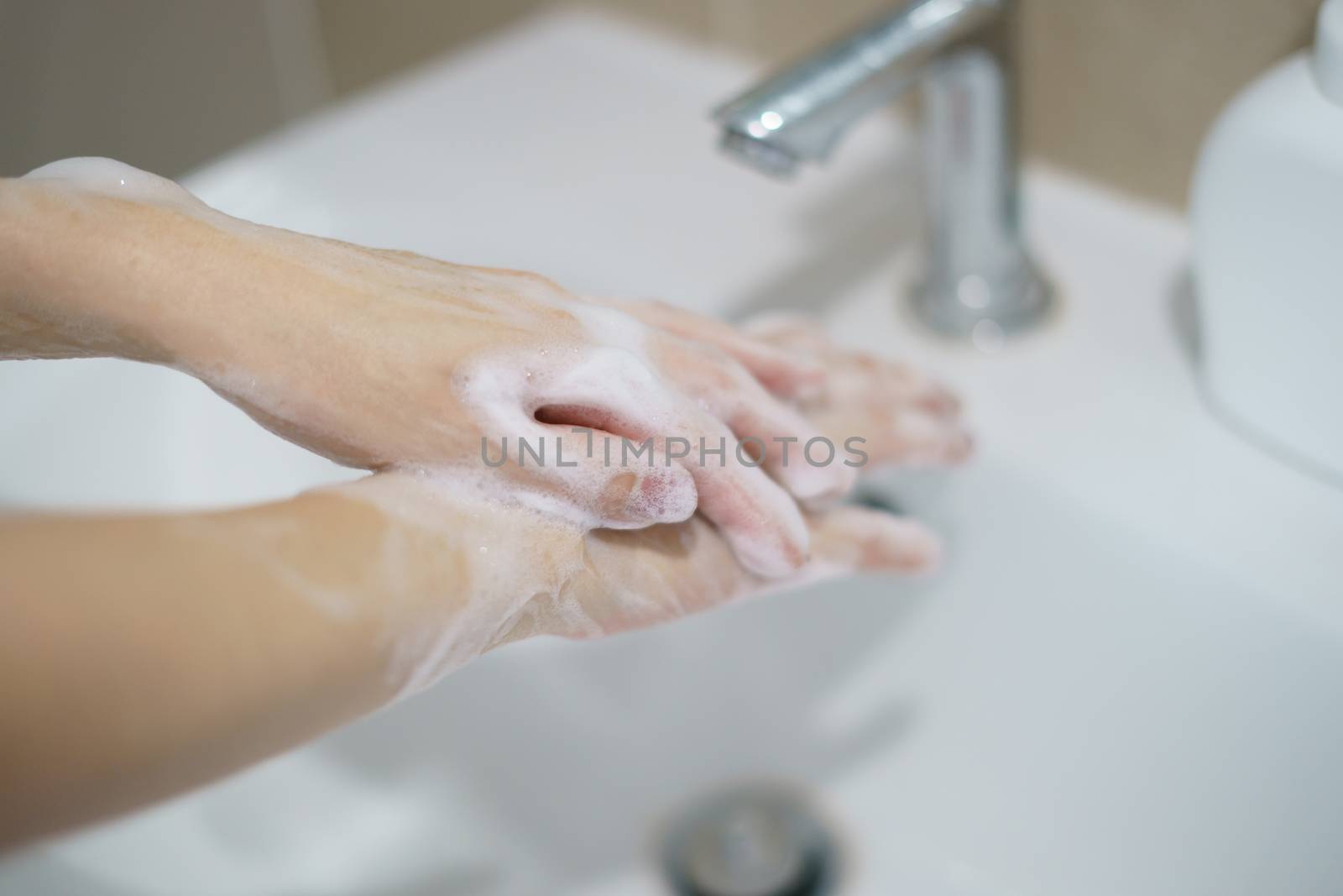 Washing hands with soap. For killing germs, bacteria and virus.