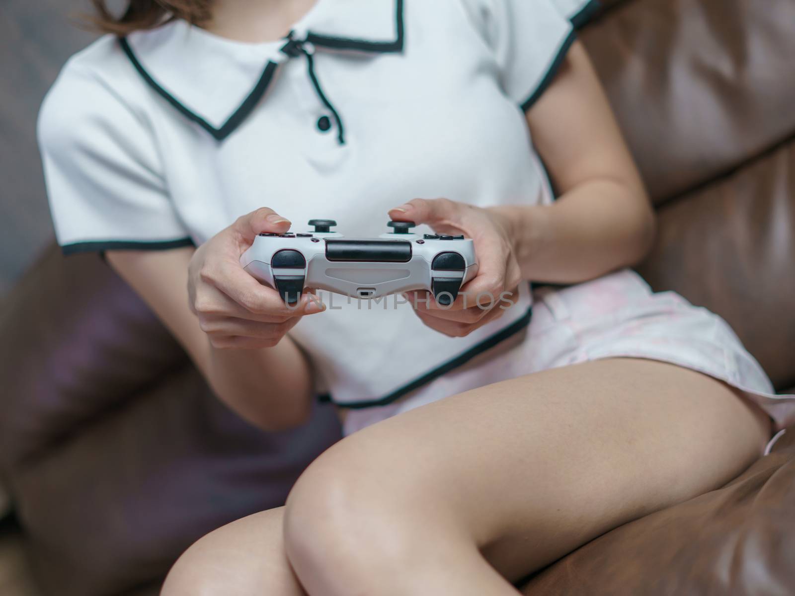 Crop of woman playing console games, Woman enjoying in video gam by sirawit99