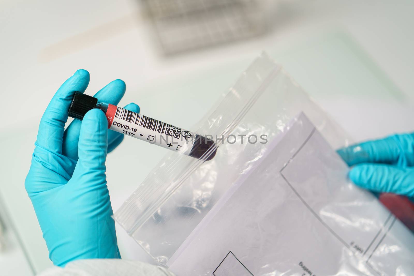 Coronavirus testing, a hand taking a tube of blood test samples by sirawit99