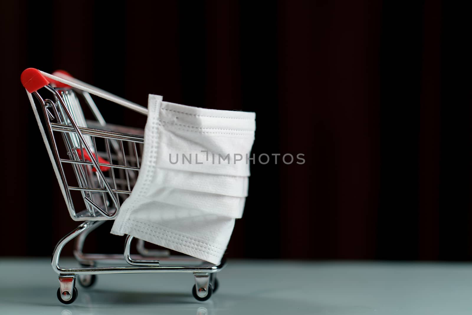 Shopping cart with protective face mask corona virus or Covid-19 by sirawit99