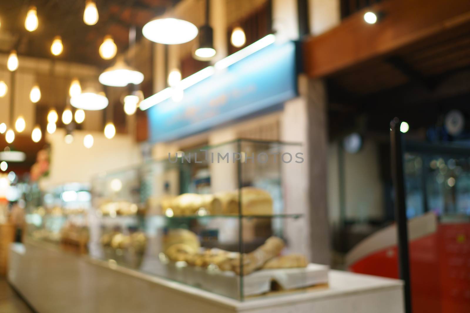 Blurred of supermarket with product shelves background image.