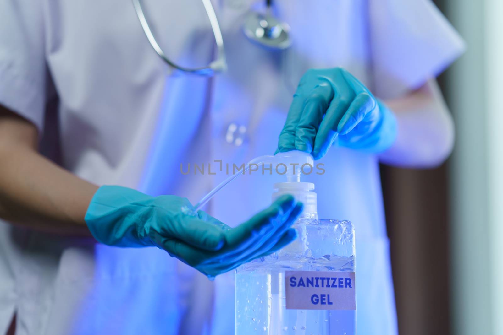 Doctor wash hand with disinfectant gel dispenser during the epidemic covid-19.