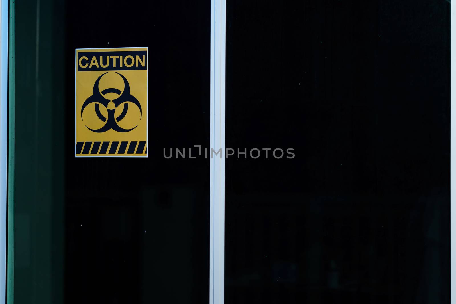 Caution danger sign. Hazard warning signs on glass window in lab by sirawit99