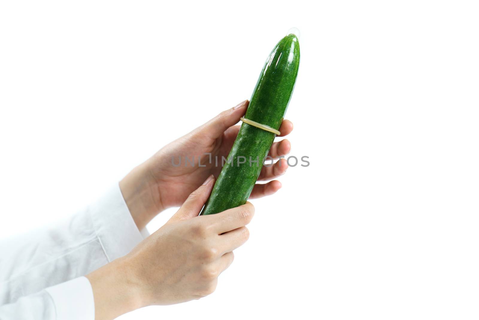 Woman hand hold cucumber with condom on white background. isolated