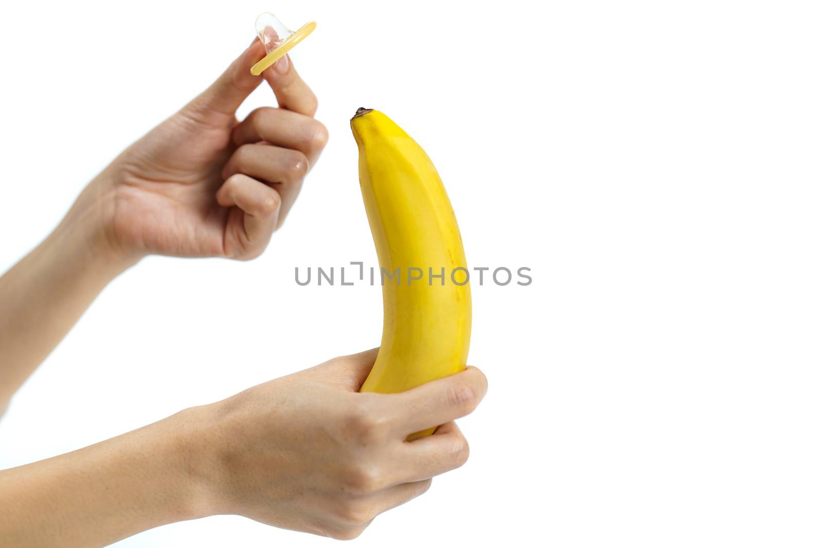 Condom on banana on white background, Safe sex concept. isolated by sirawit99