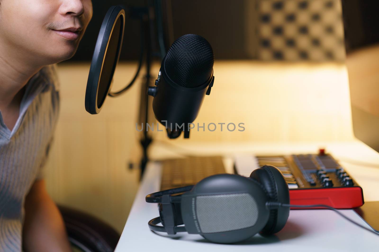 Mand using condenser microphone with earphone and sound mixing c by sirawit99