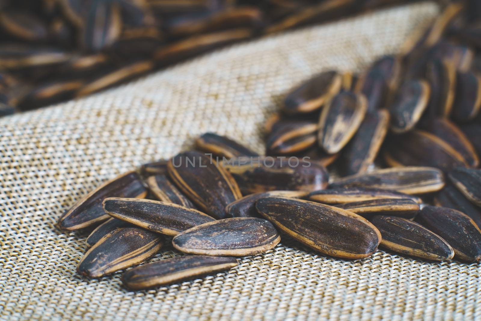 Sunflower seed on a sack background. by sirawit99