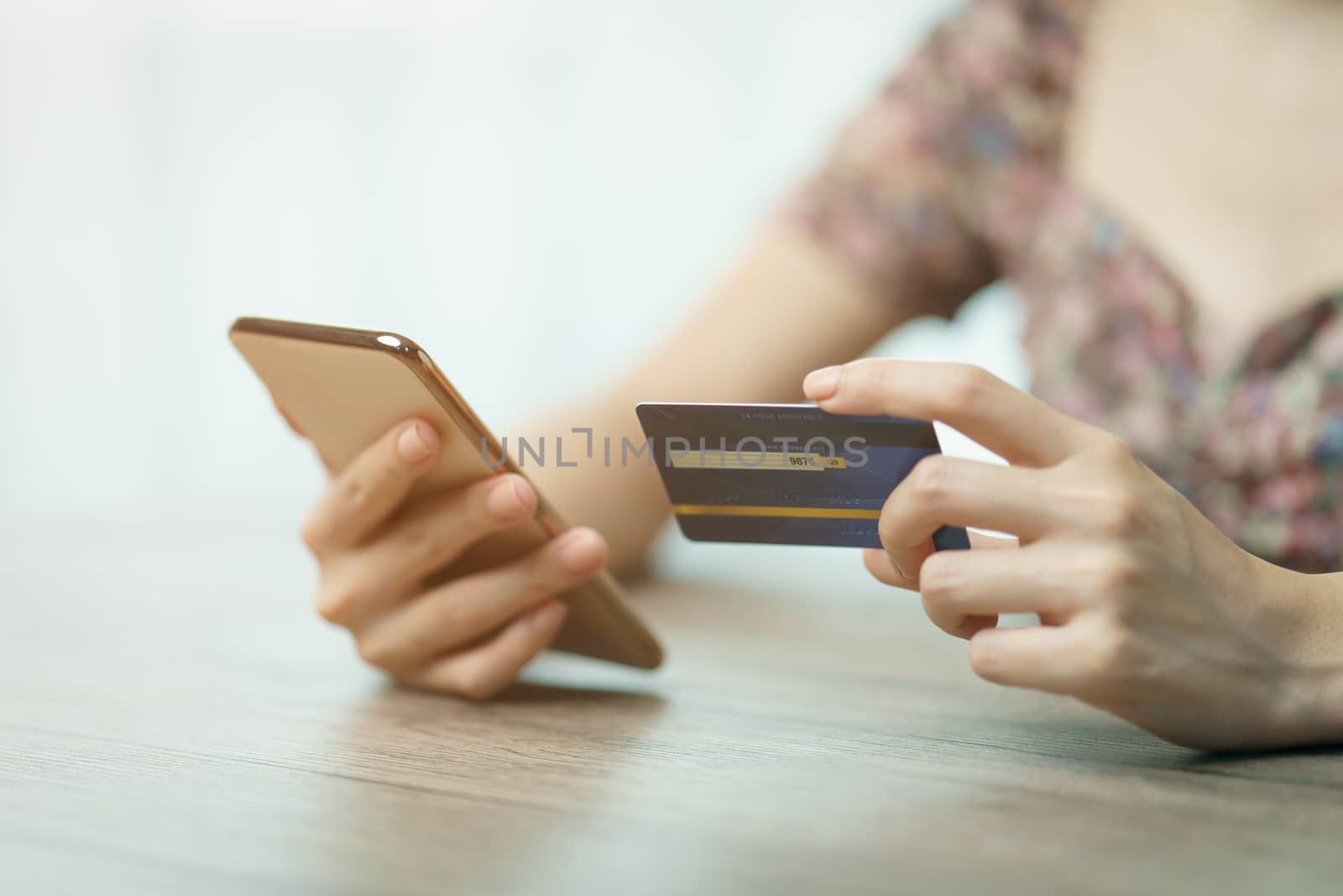 Online shopping concept : woman hands holding cradit card and us by sirawit99