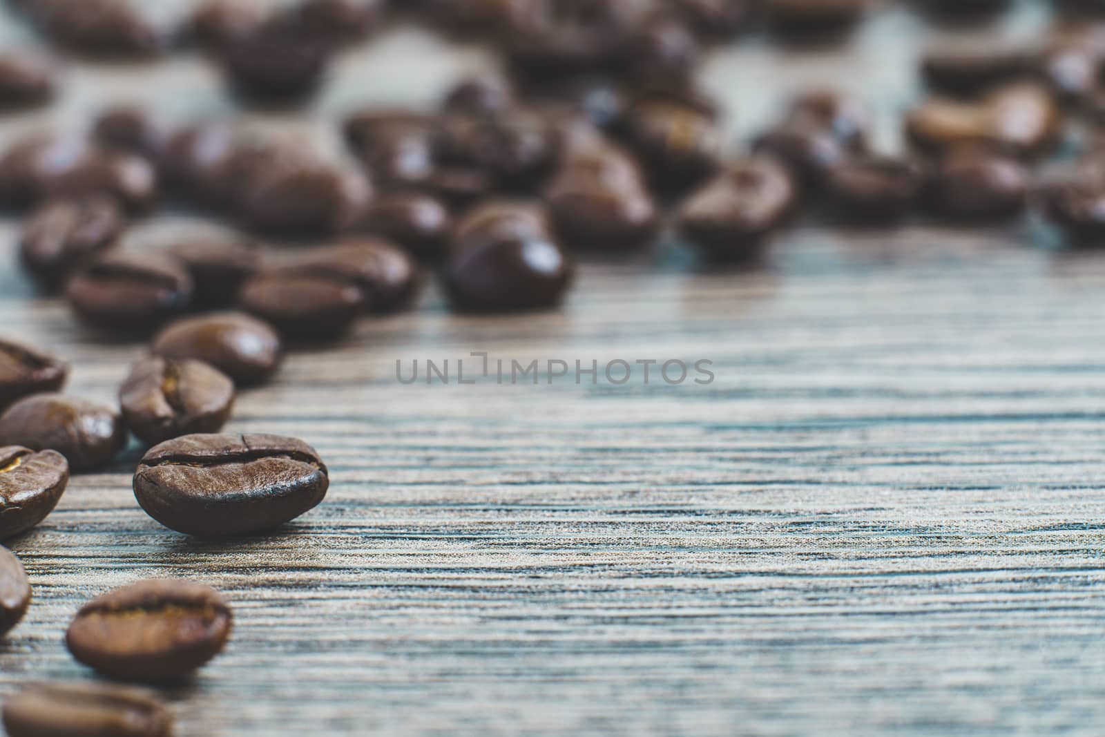Coffee beans. On a wooden background.