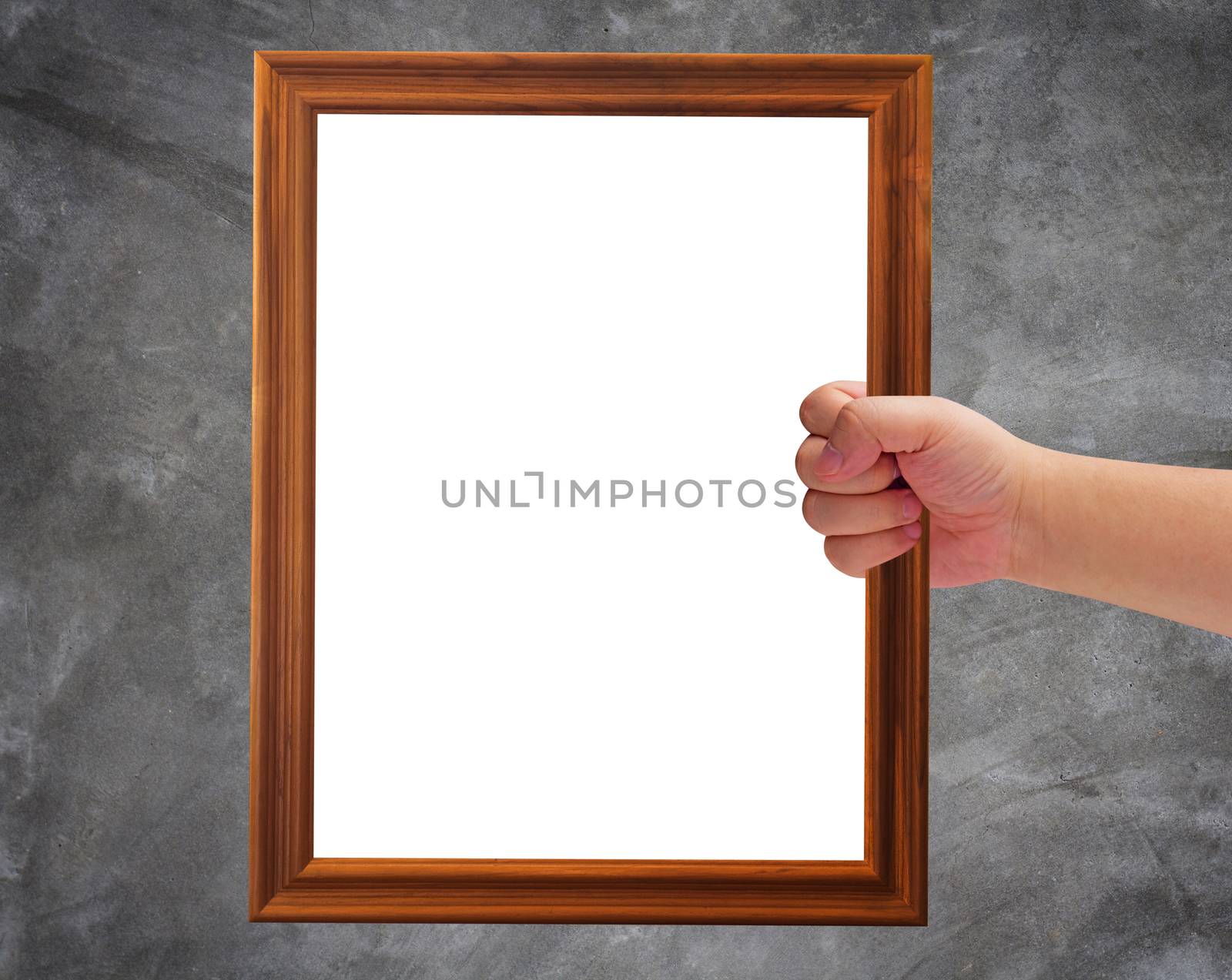 Communication and announcement concept, hand holding wooden frame on concrete background