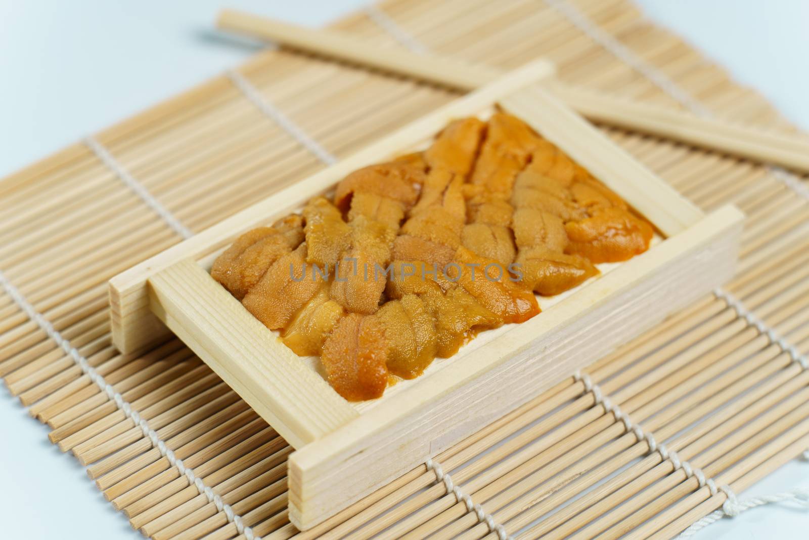 Japanese sea urchin in wooden tray , sushi and sashimi ingredients