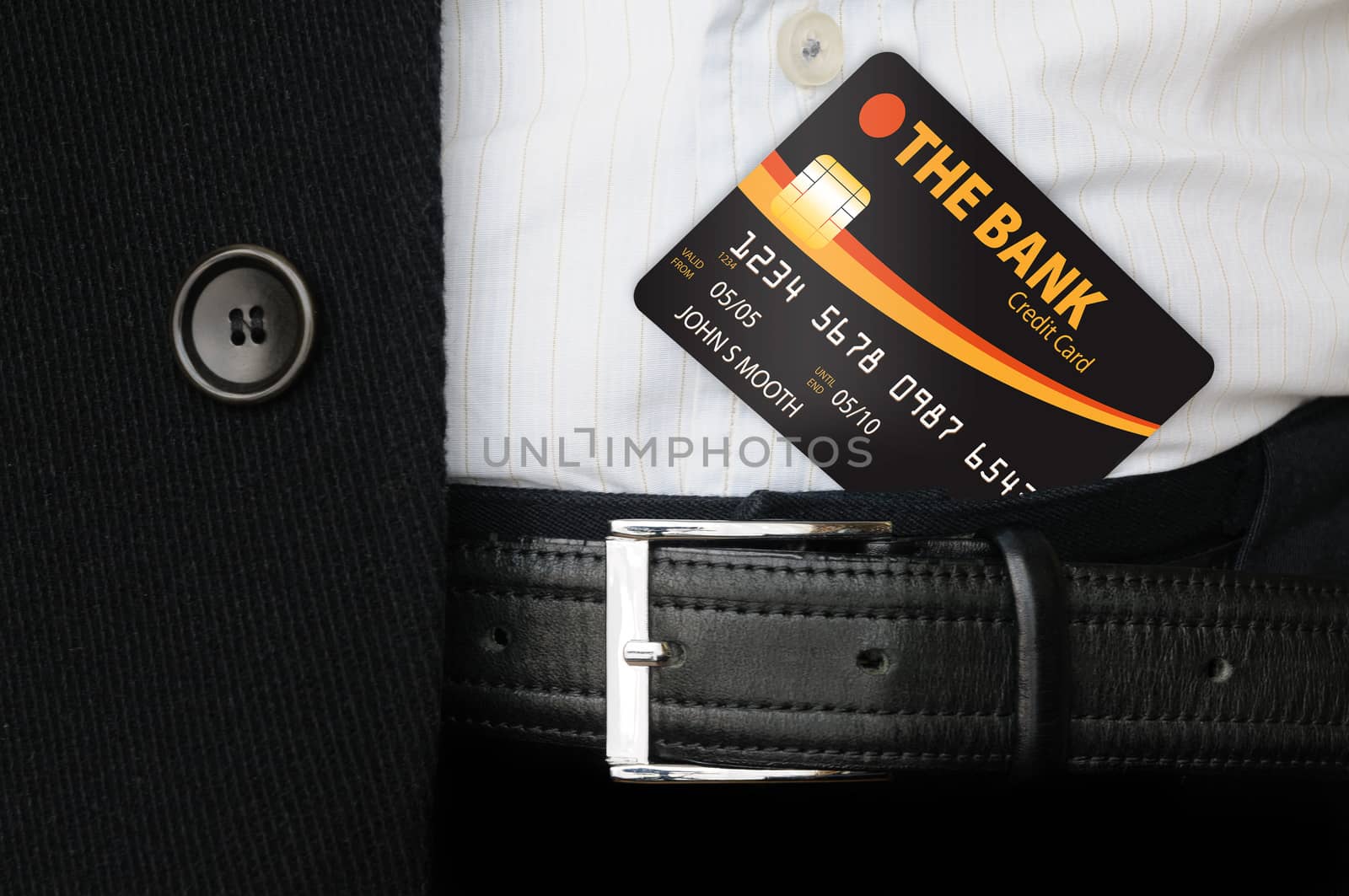 A man holding a credit card under his trousers' belt, and showing it