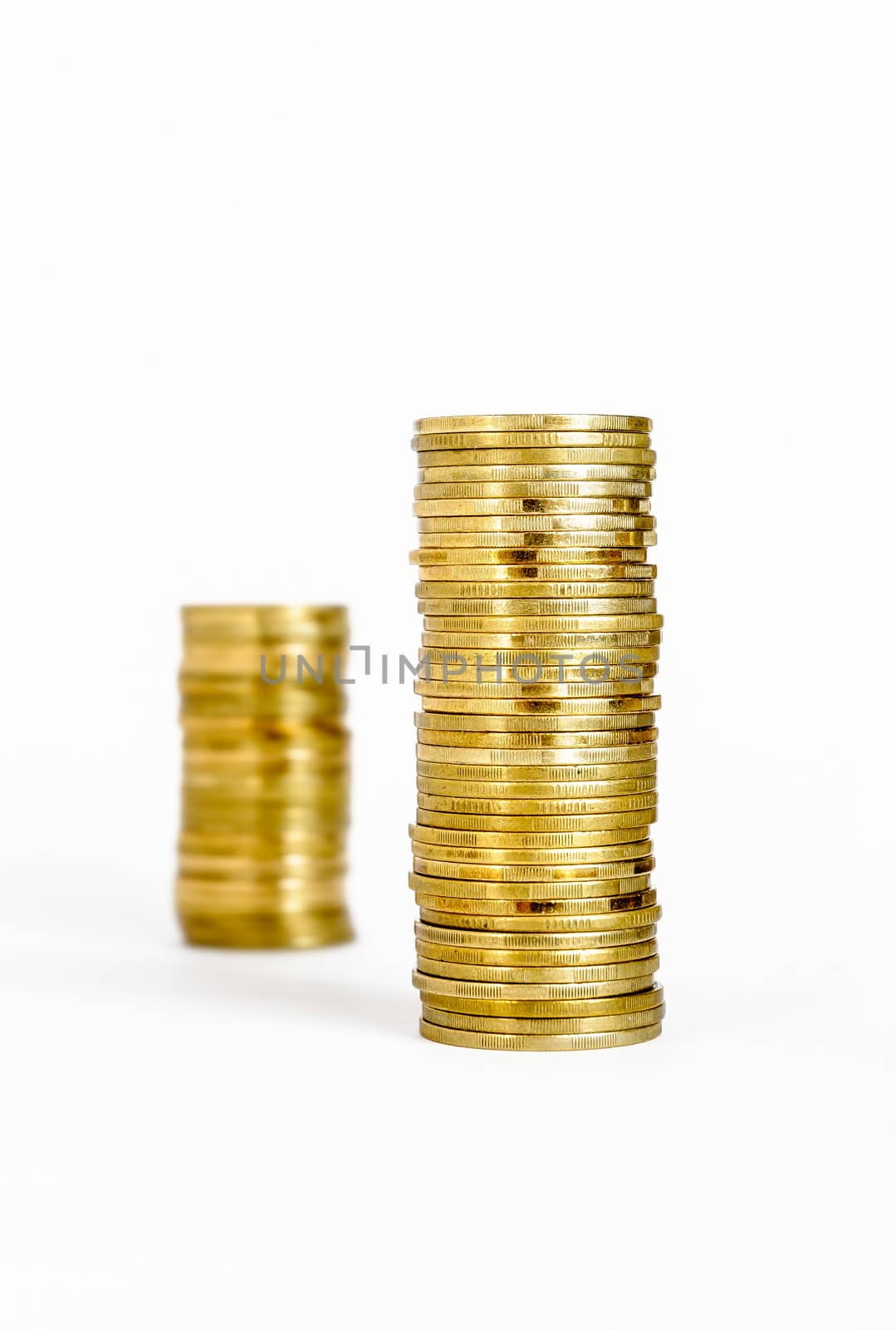 Two piles of coins, one blurred in the background