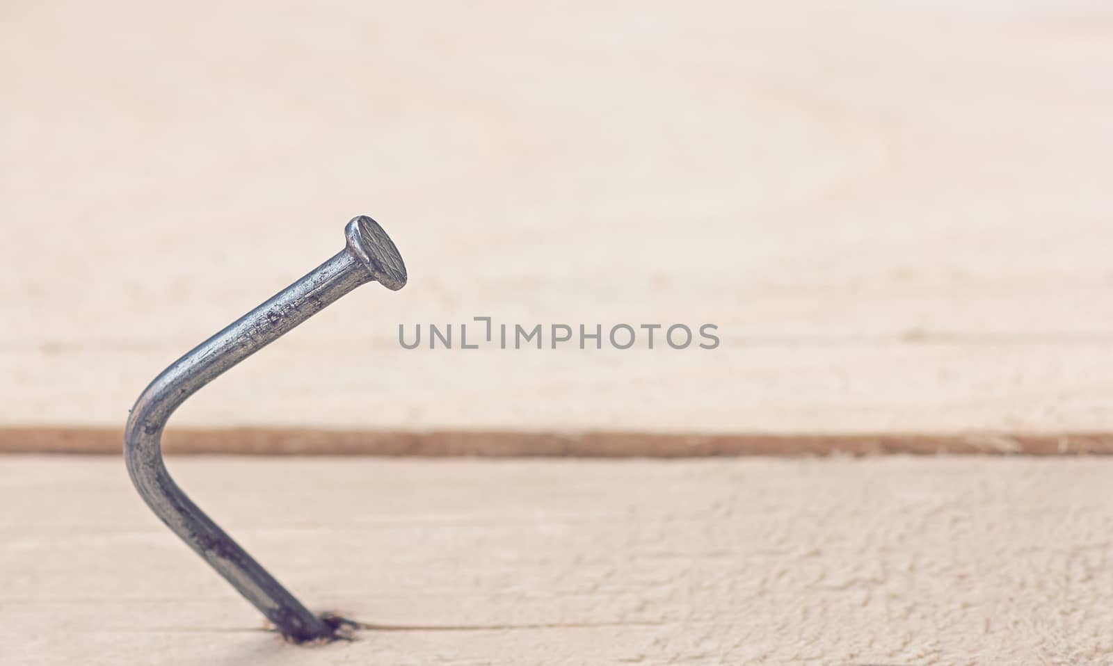 Business solution, problem concept, bend nail on wood background, vintage and retro