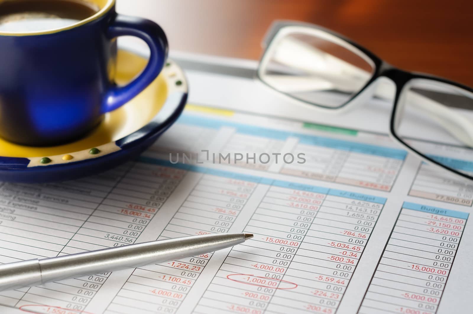 Accounting form with pen, in the businessman's office, close to a cup of coffee