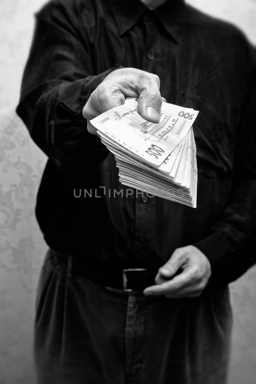 Corrupted businessman, or politician, offering a Hryvnia banknotes bribe, in Ukraine