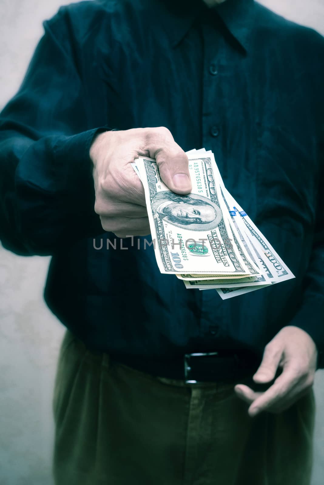 Corrupted businessman, or politician, offering a Dollar banknotes bribe