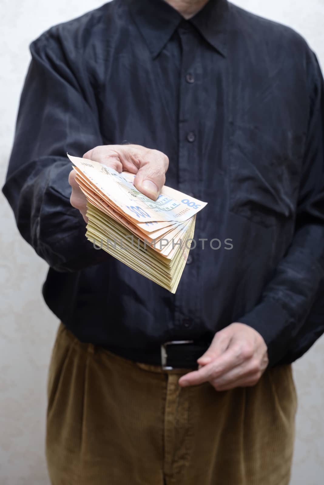 Businessman, or politician, offering a Hryvnia banknotes bribe f by MaxalTamor