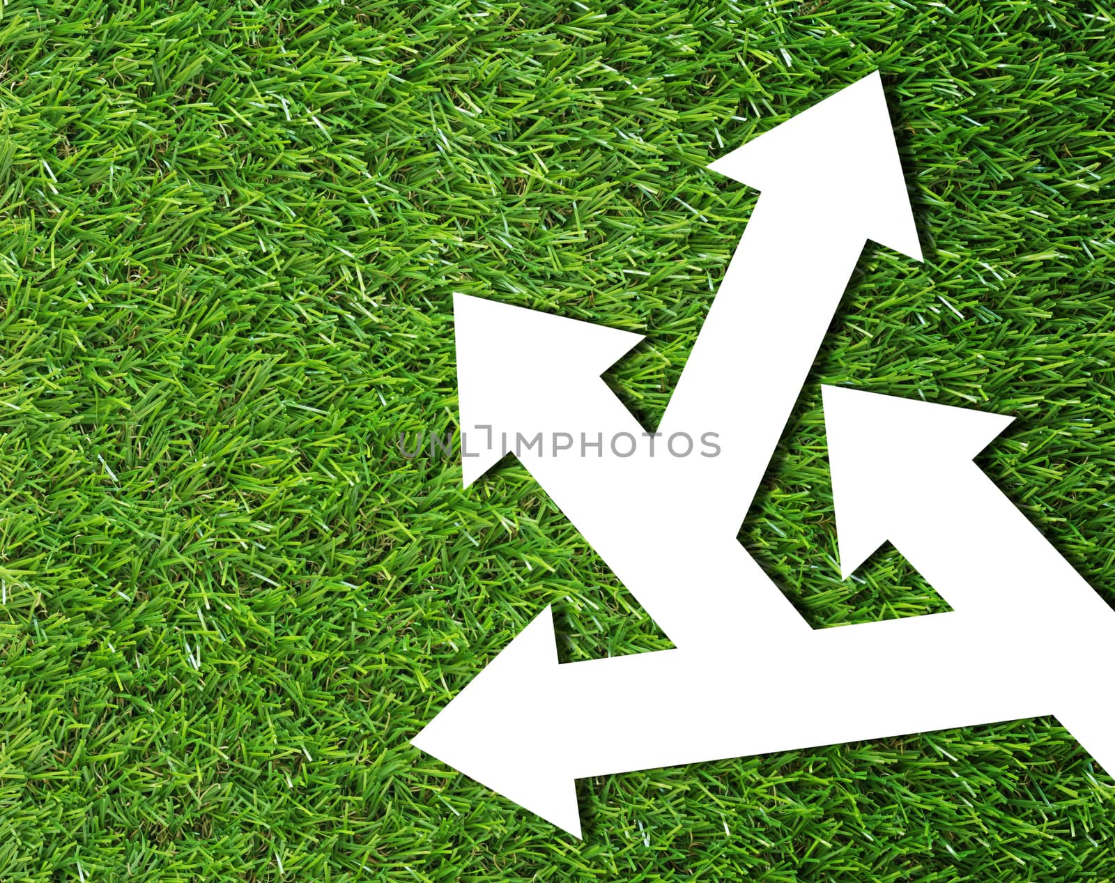 Business problem or confused concept, white arrow on green grass background