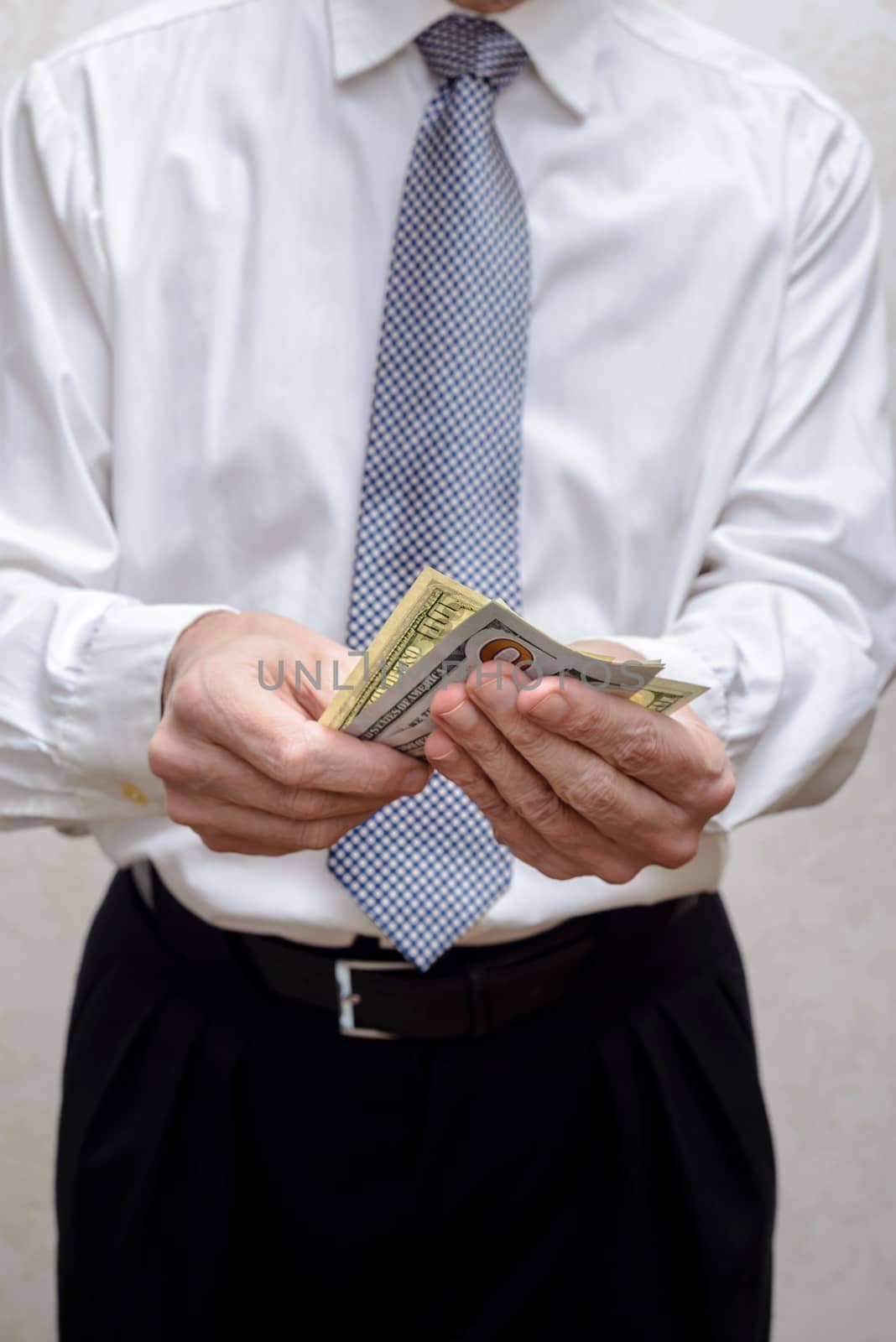 Corrupted businessman, or politician, counting and offering a Dollar banknotes bribe