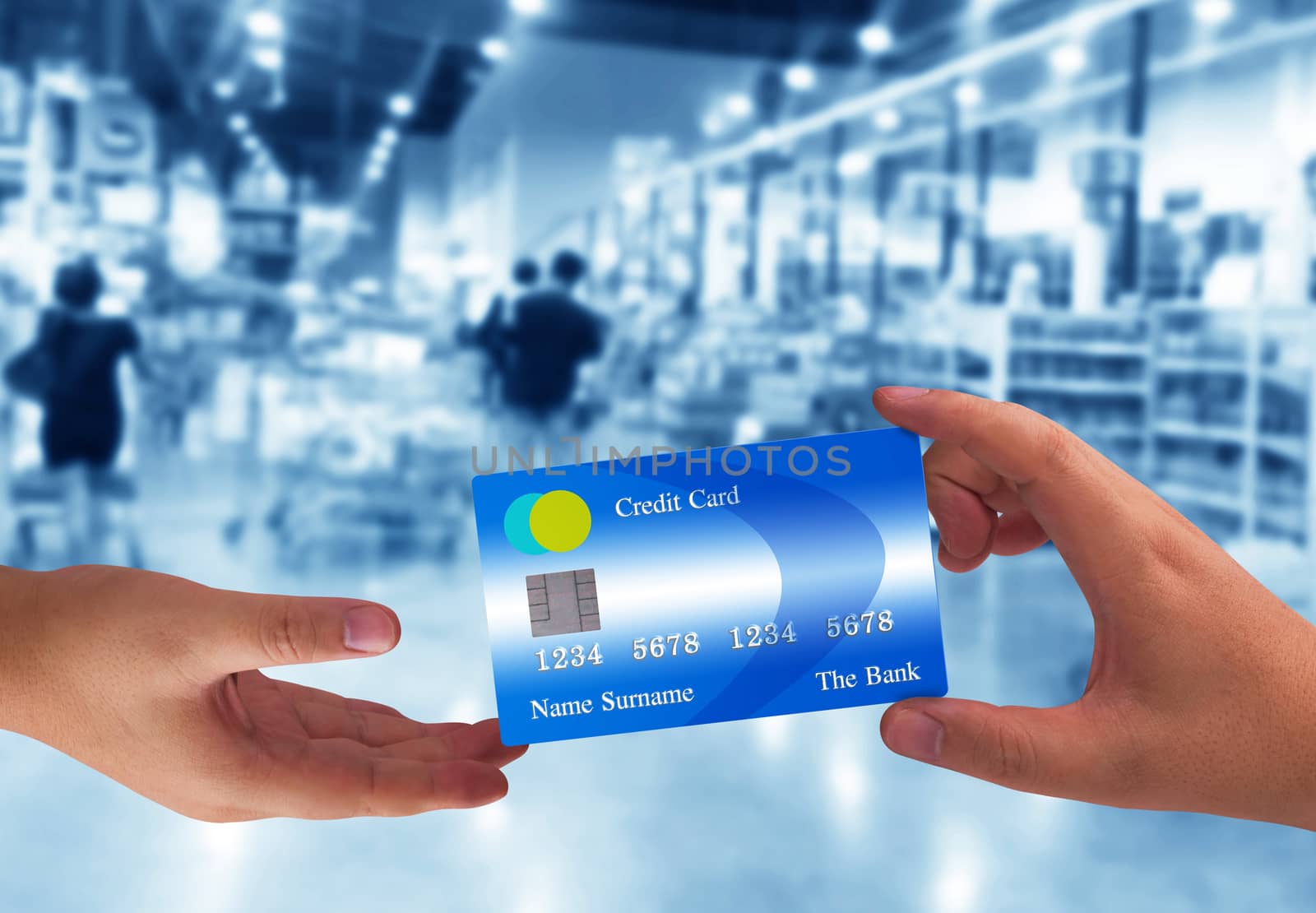 Hand holding credit card on super market blur background, online payment, electronic commerce financial concept  
