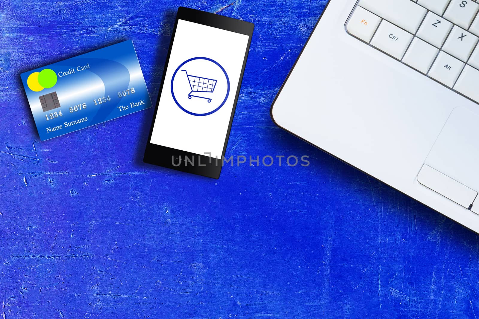 Online shopping concept, mobile phone, credit card and laptop on blue vintage background with copy space