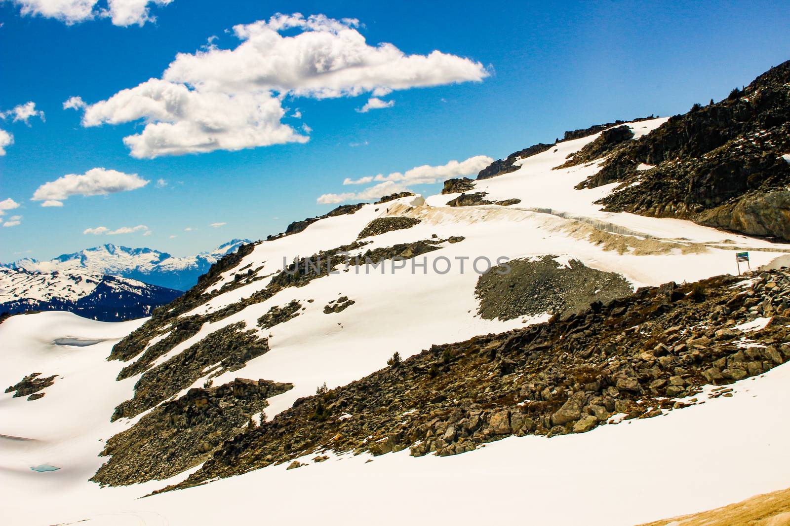 Blackcomb mountain peak panorama view cloudy sky summer time. Blackcomb mountain peak panorama view cloudy sky summer time by mynewturtle1