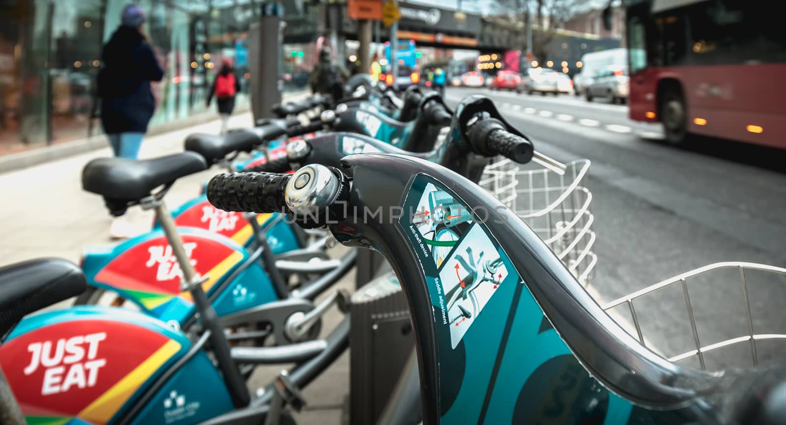 Dublin, Ireland - February 11, 2019: Detail of a shared public bike station Just Eat dublinbikes in the city center on a winter day