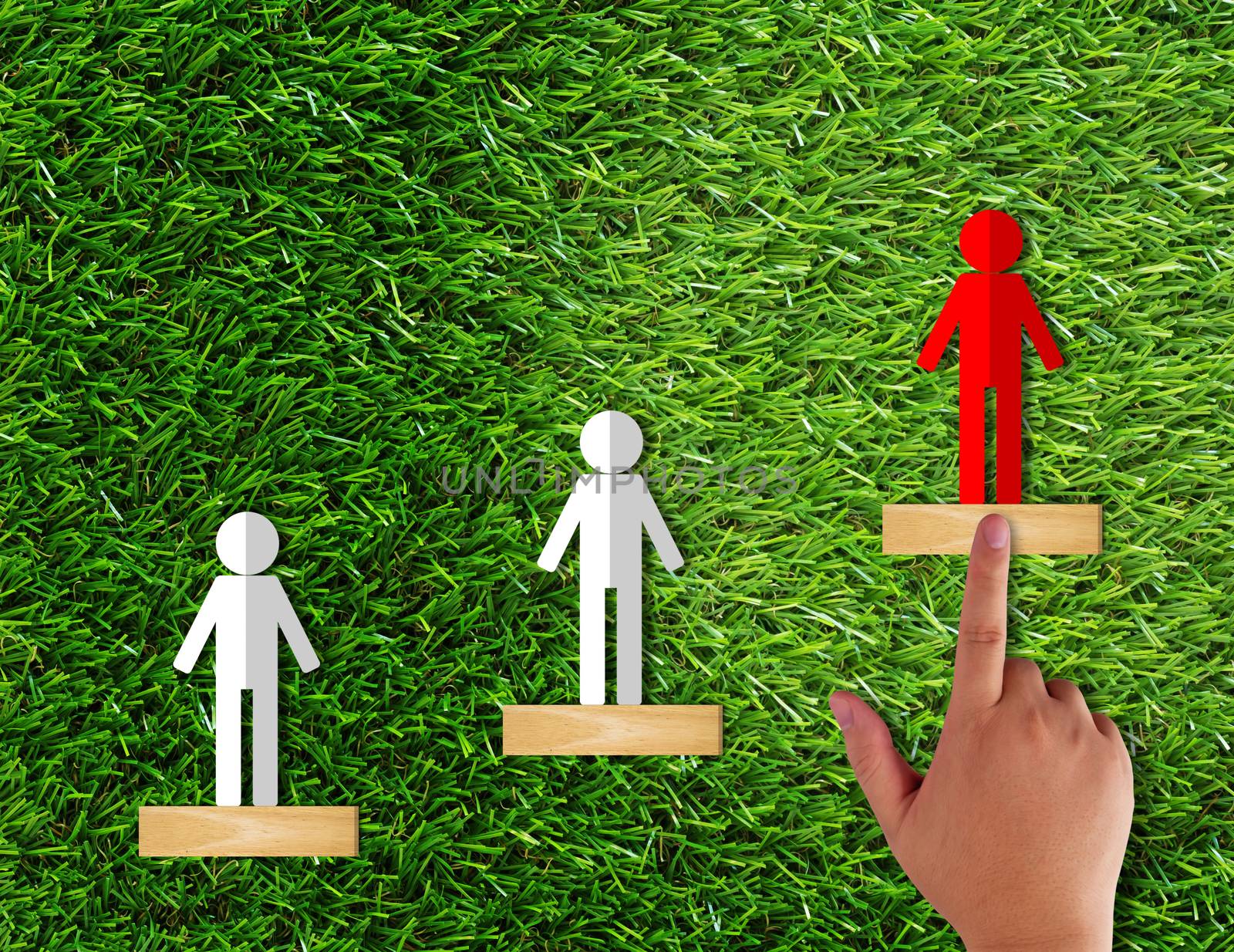 Leadership concept, paper people on green grass background, business success concept