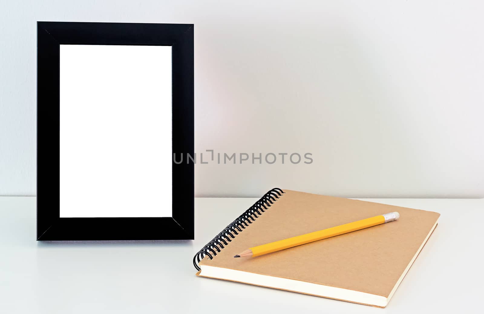 Desktop frame, notebook and yellow pencil, memory concept 