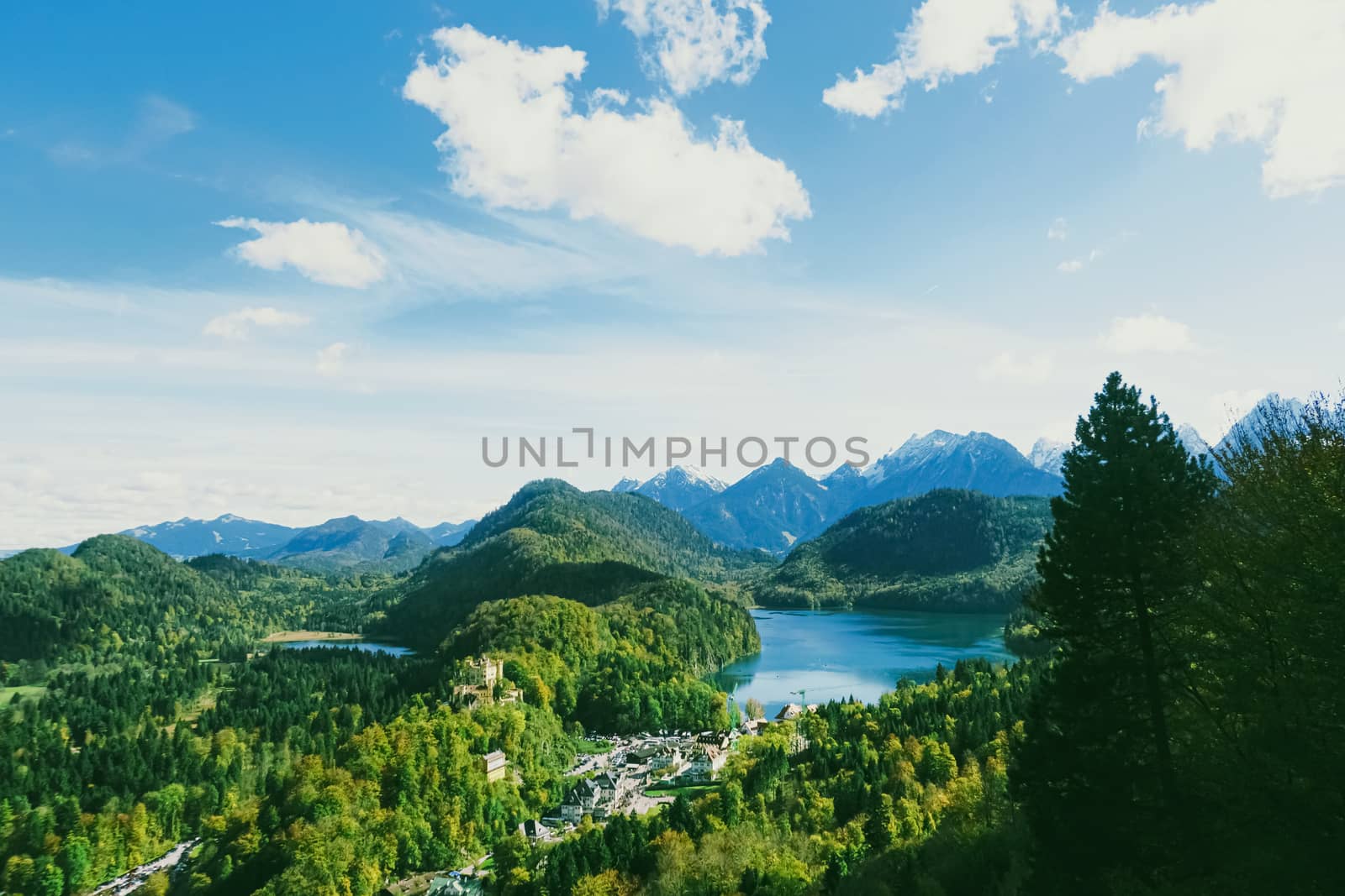 Beautiful nature of European Alps, landscape view of alpine mountains, lake and village in spring season, travel and destination scenery