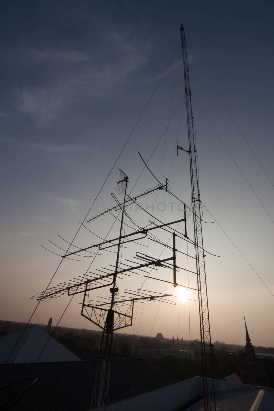 Silhouette Telecommunication mobile antenna on roof building. communication network technology concept.