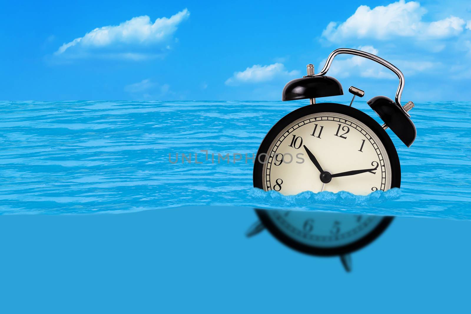 Waste of time concept, alarm clock on the water