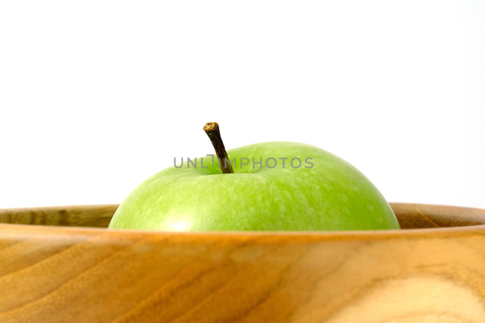 Close up green Apple granny smith above wooden bowl / basket isolated on white background