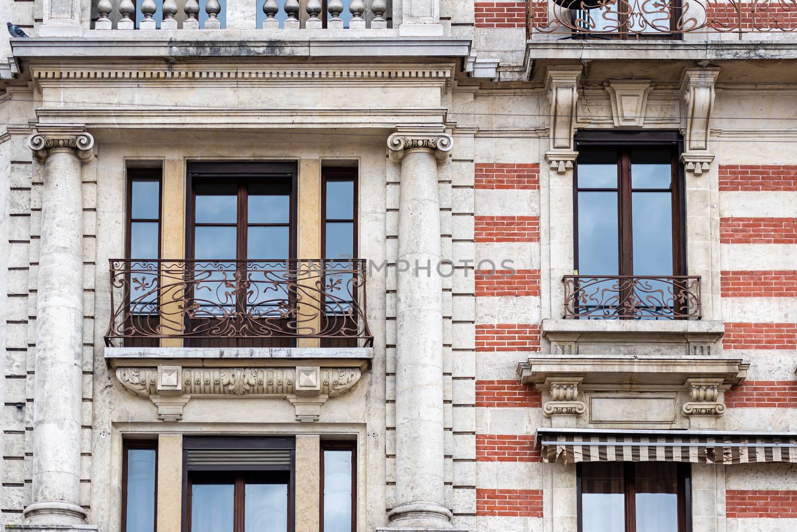 Facade of a historic brick building with metal balconies. Geneva, Switzerland - image