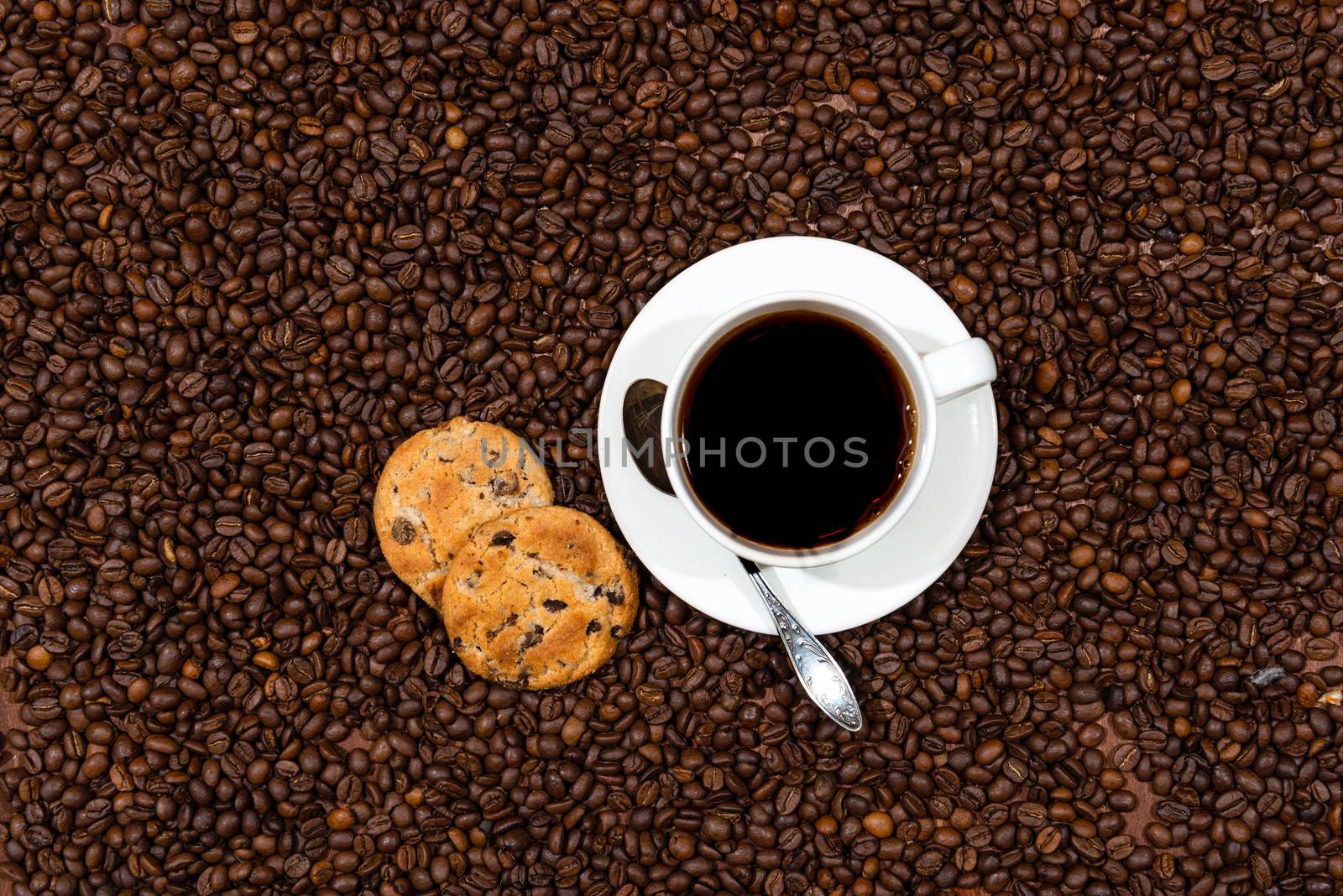 White coffee mug and cookies on the coffee beans background, top view - image