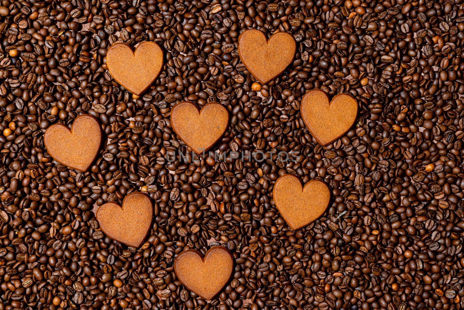 Heart-shaped gingerbread cookies on the coffee beans background - image