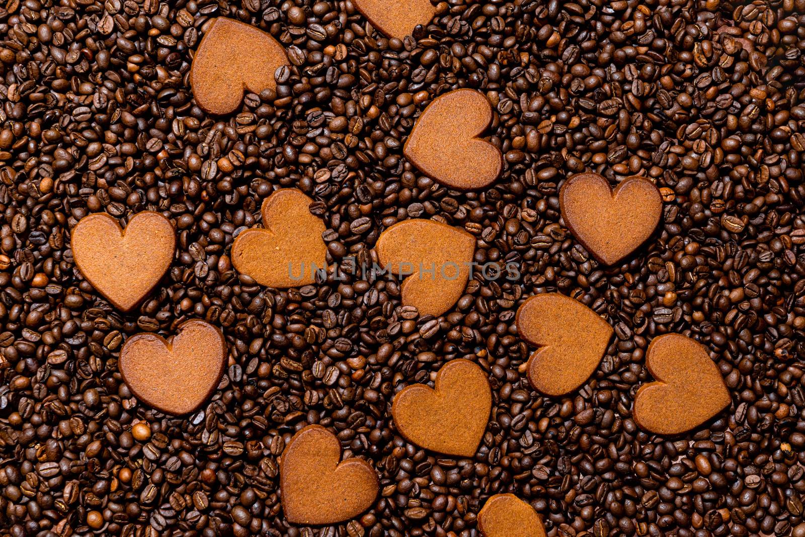 Heart-shaped gingerbread cookies on the coffee beans background - image