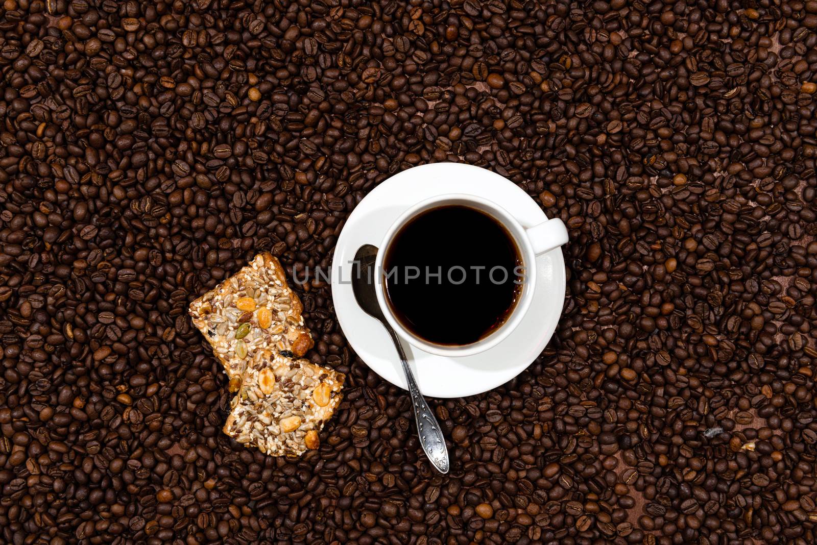 White coffee mug and cookies on the coffee beans background, top view - image