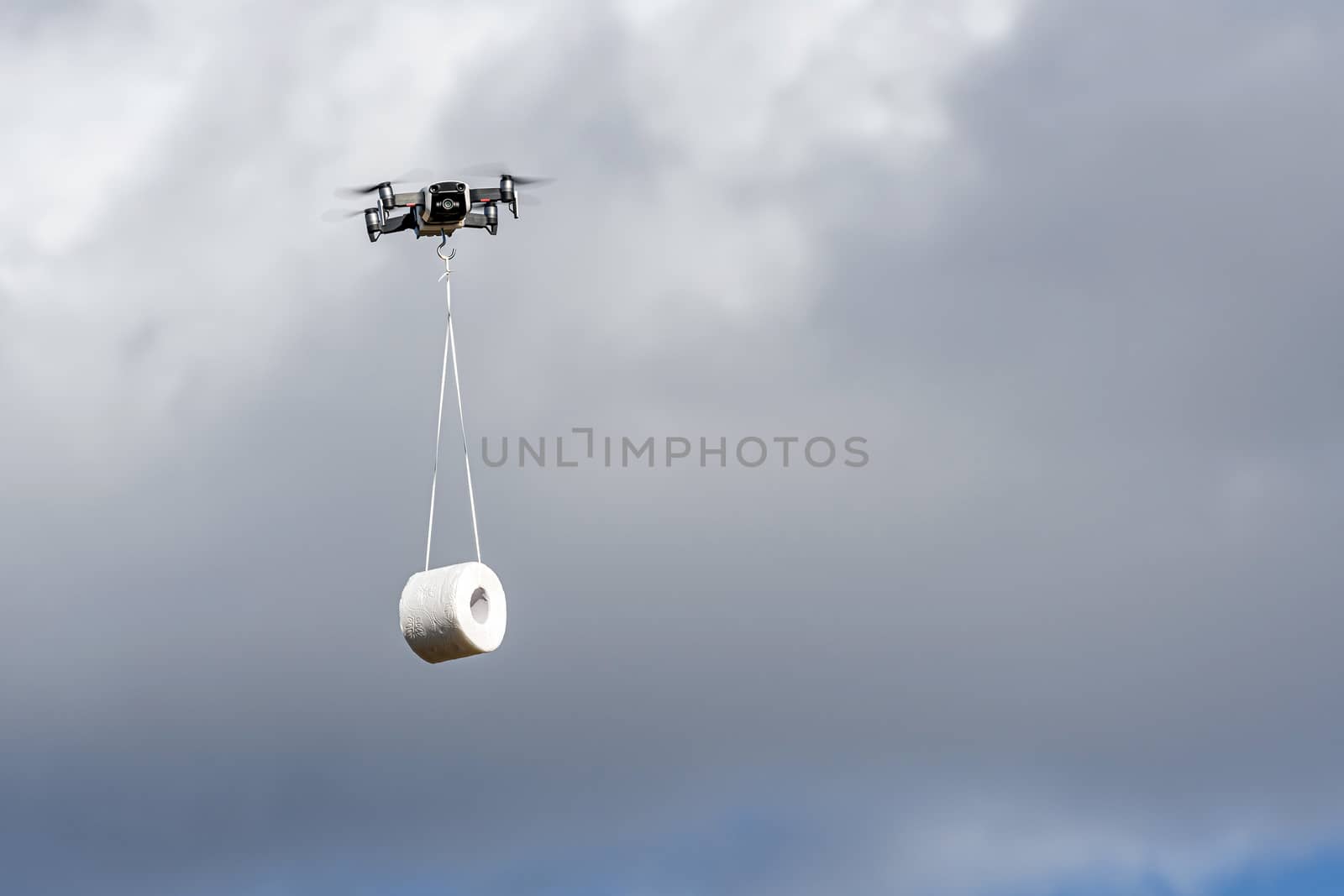 the drone is flying with the toilet paper roll to the customer, concept of Drone delivery