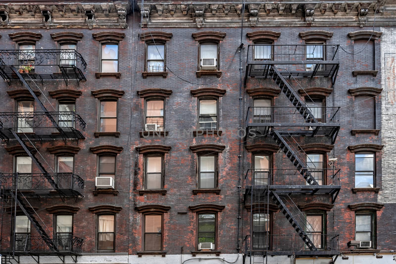 bricks buildings facades with fire escape stairs