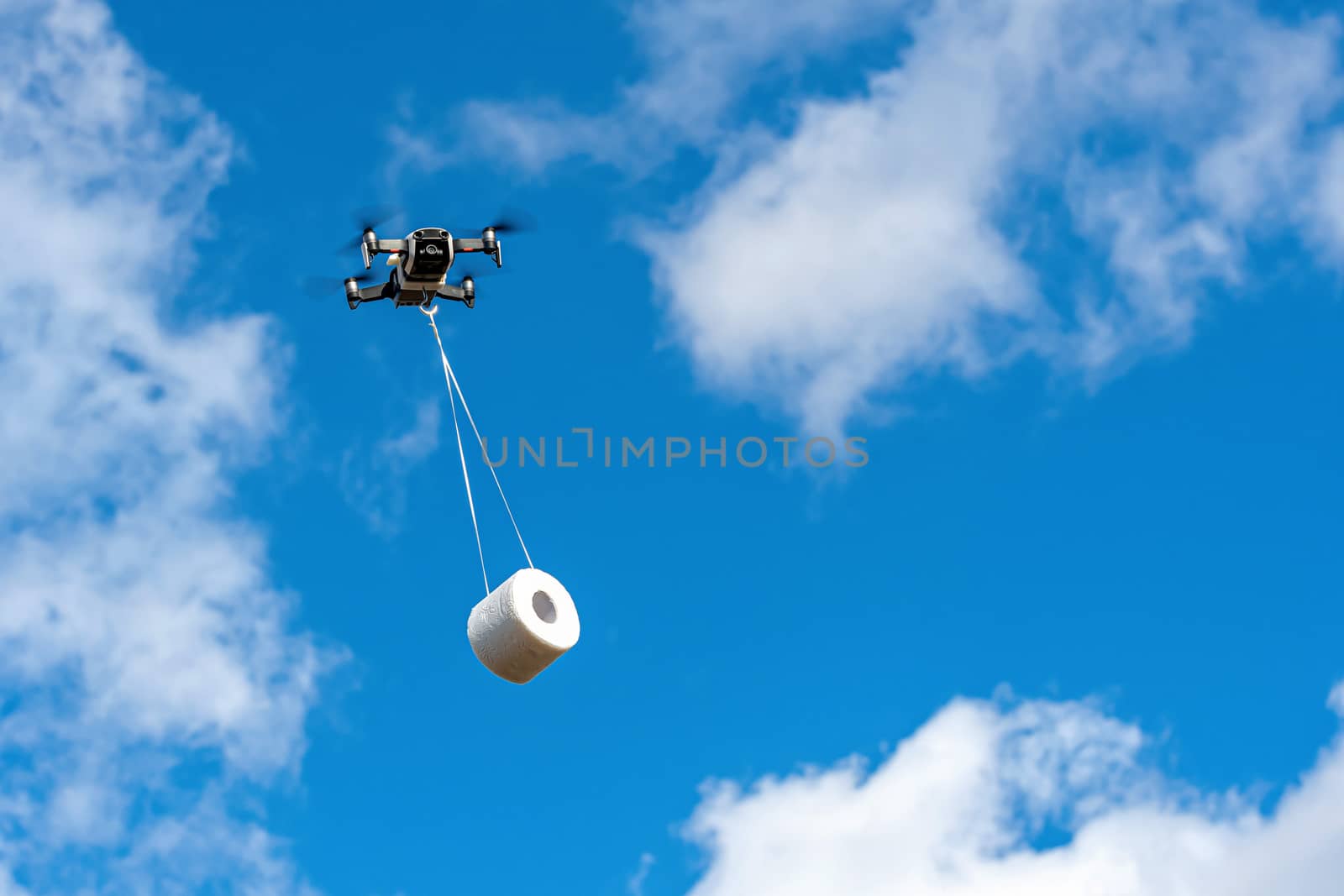 the drone is flying with the toilet paper roll to the customer, concept of Drone delivery