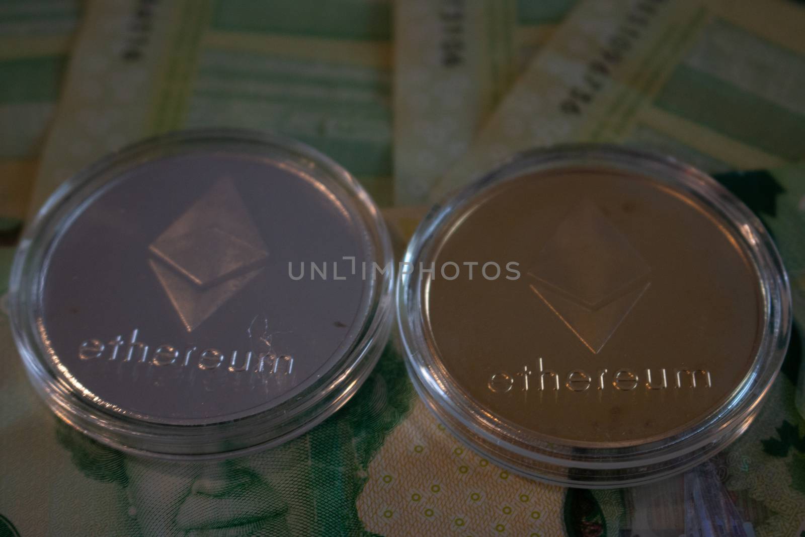 London Canada, January 24 2020: Editorial Illustrative photo of Etherum coins on Canadian currency. Etherum is a leading crypto currency. by mynewturtle1