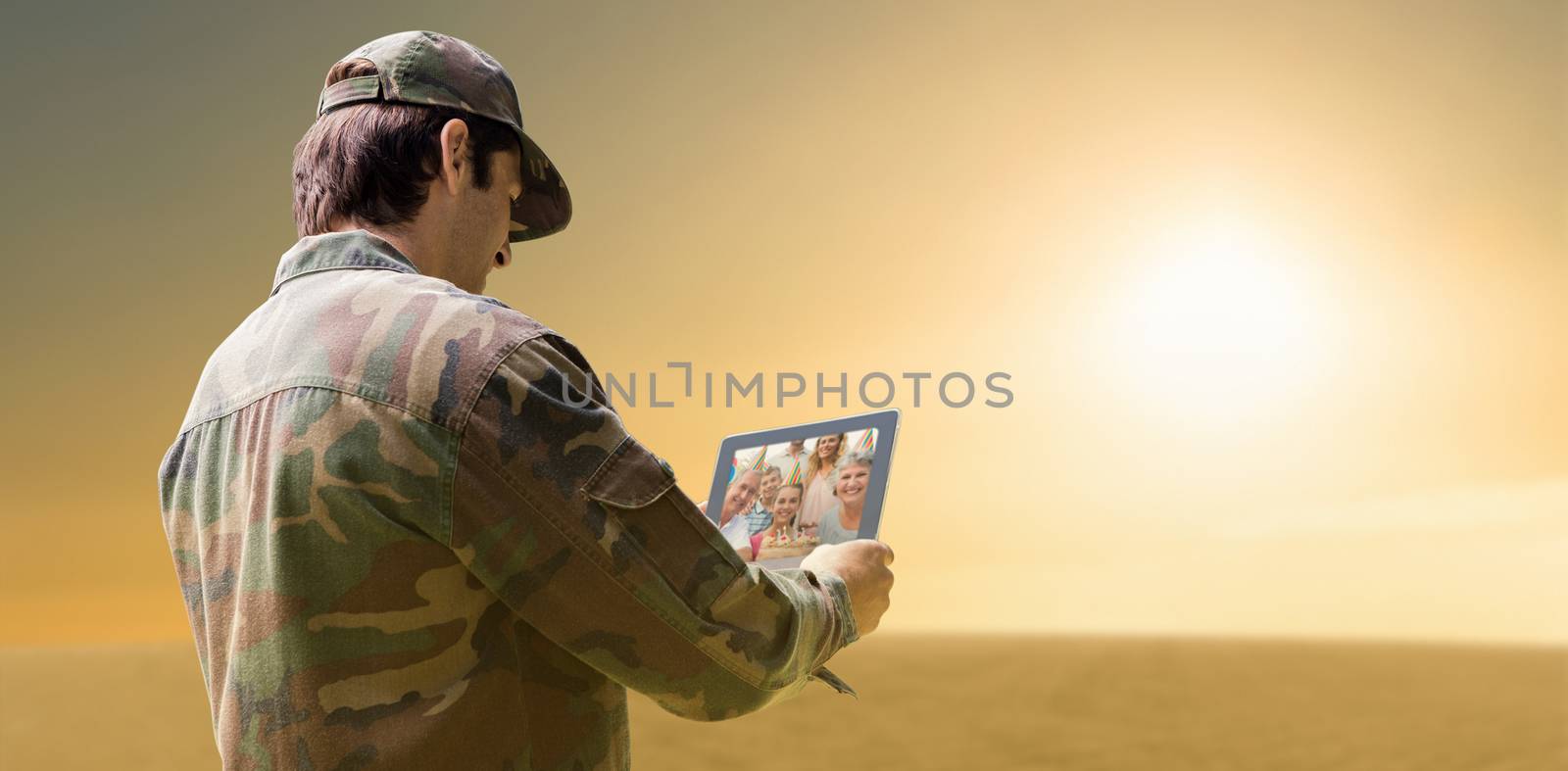 Army officer using tablet against desert scene