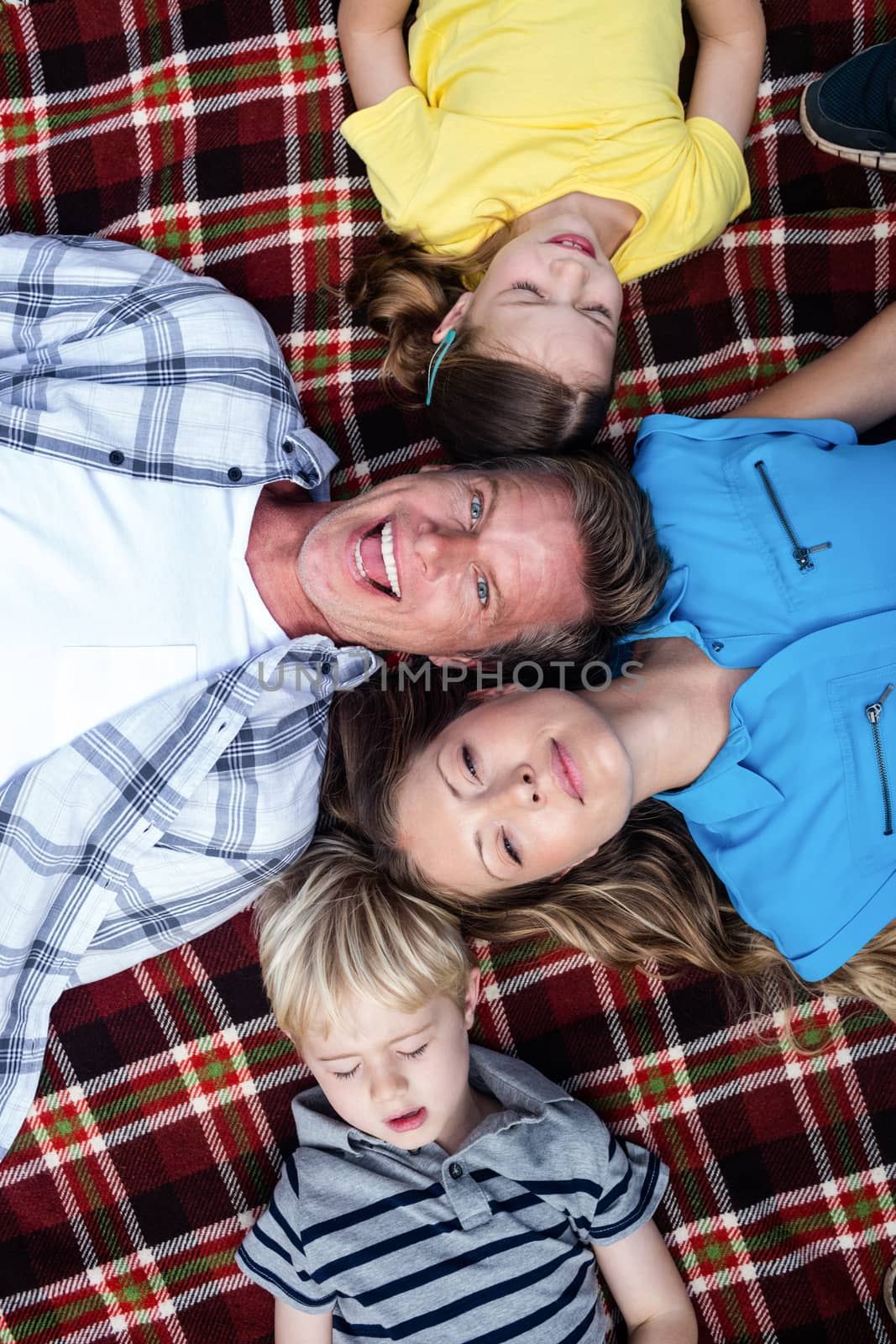 Family lying together in the park by Wavebreakmedia