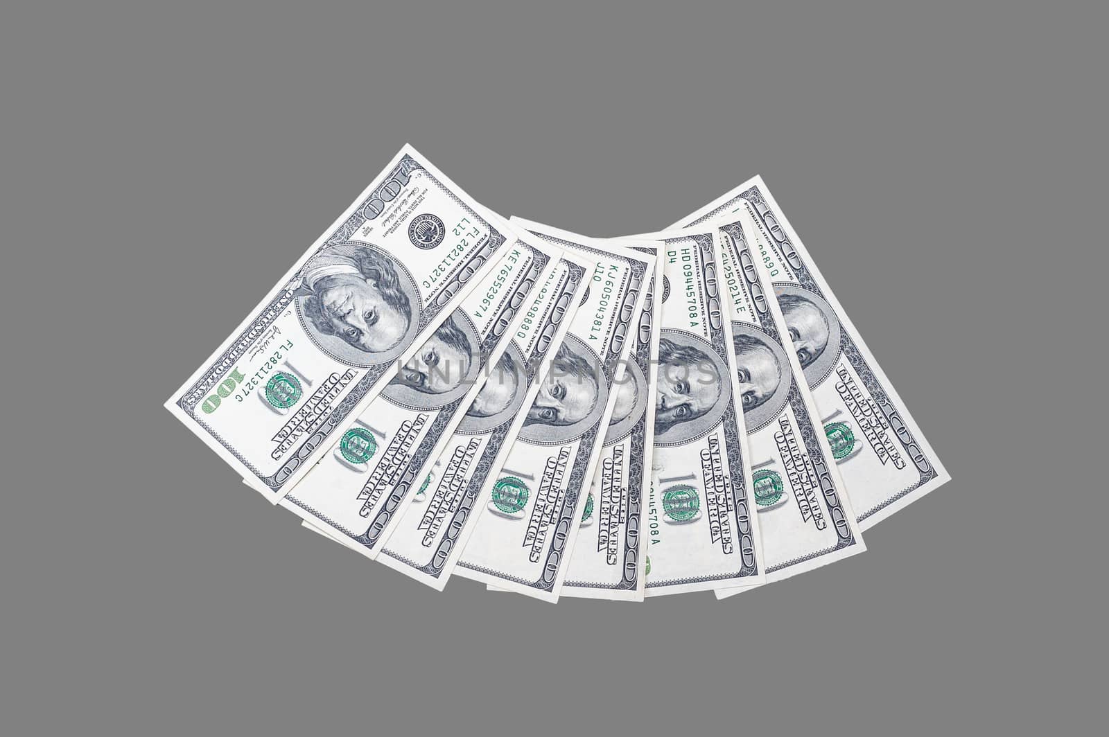 100 US dollar bills with a portrait of US President Benjamin Franklin on an isolated gray background